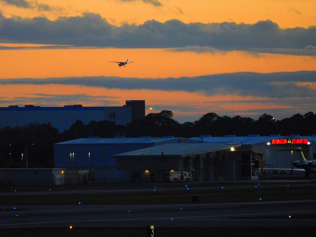Plane Flying Against Sunset
